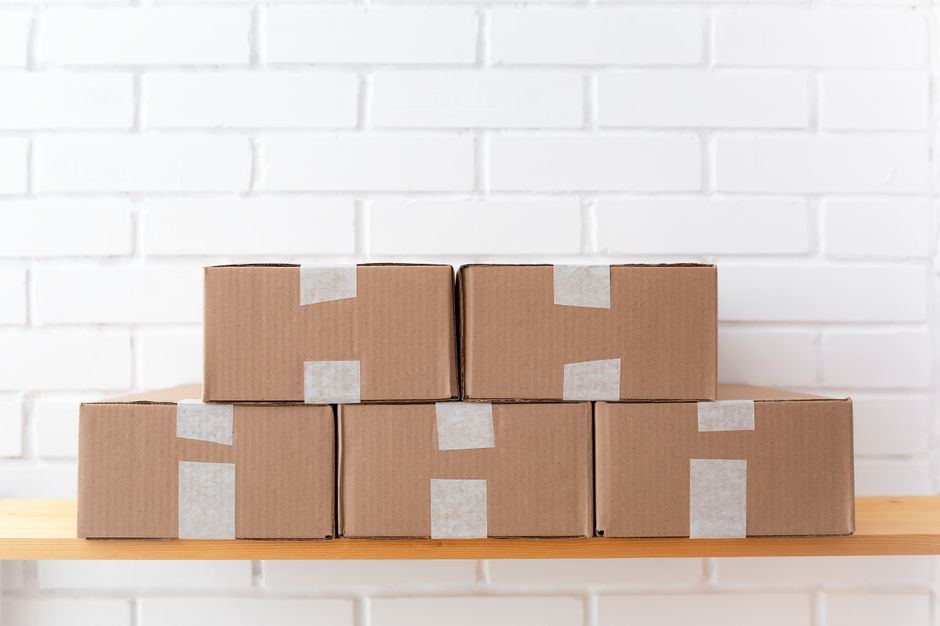 Taped cardboard boxes stacked on a shelf