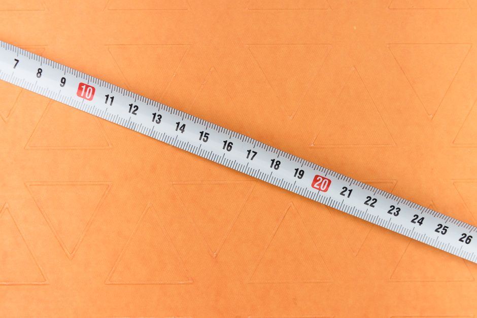A tape measure being used inside a box