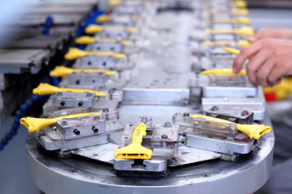 A plastics production line with yellow handles